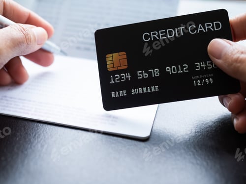 Preview: Finger Holding Credit Card with blur bank Account and Pen