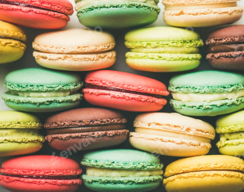 Preview: Colorful French macaroons cookies stacked in rows