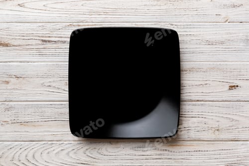 Preview: Top view of empty square plate on wooden background. Empty space for your design