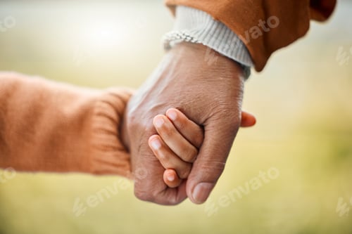 Preview: Families are special. Shot of a little girl holding her fathers hand outside.