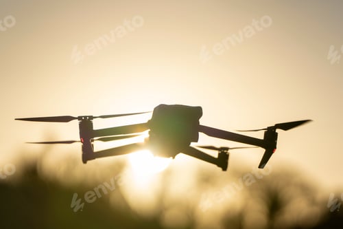Preview: Drone quadcopter with digital camera and fast rotating propellers flying taking video and pictures