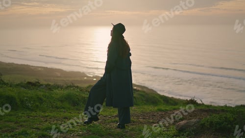 Preview: Silhouette woman standing sunset on seashore. Elegant girl posing on nature.