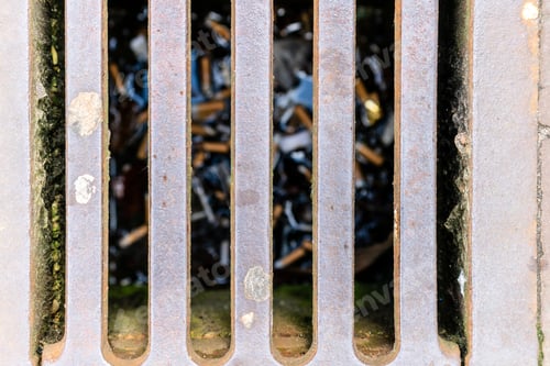 Preview: Cigarette butts in drain water sewer focus on grill