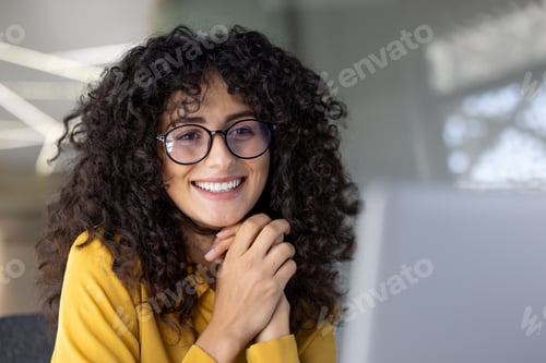 Preview: Young businesswoman working with laptop close-up, woman smiling happily reviewing and reading