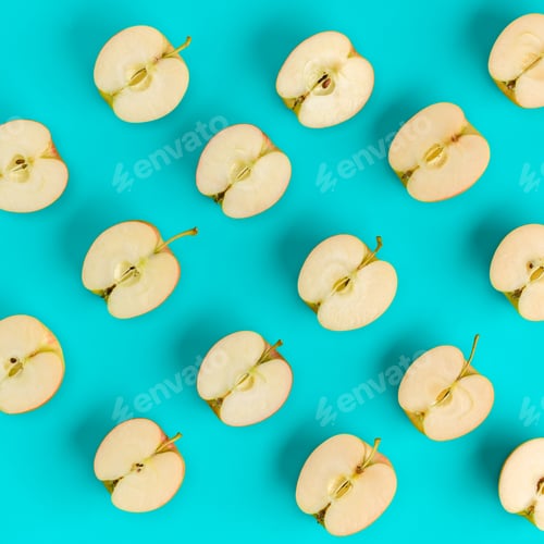 Preview: Fruit pattern of apple halves on blue background. Flat lay, top view. Food background.