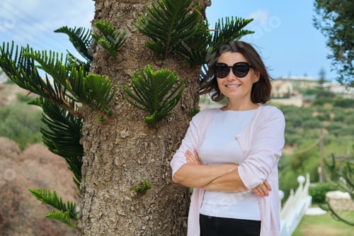 Preview: Beautiful middle-aged woman with arms crossed, copy space