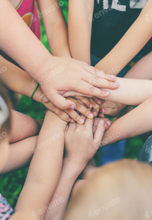 Preview: Children's hands together, street games. Selective focus.