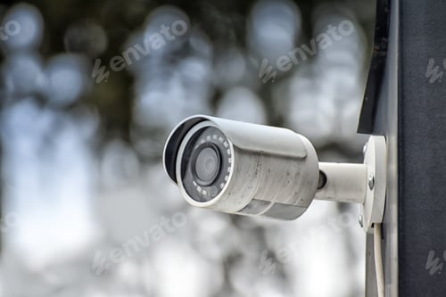 Preview: Security system of outdoor video surveillance, CCTV Security Camera on blurred outdoors background.