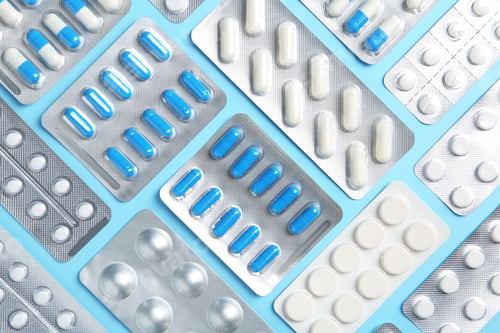Preview: Flat lay composition with pills in blister packs on color background