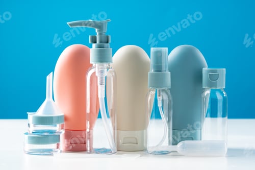 Preview: Variety of travel-sized containers displayed against a bright blue background
