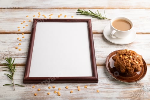 Preview: Brown wooden frame mockup with cup of coffee and cake on white wooden background. top view