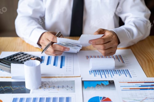 Preview: Close-up of businessman's hands collecting bills for tax refund and tax savings, finance banking and