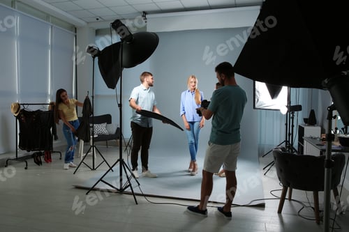 Preview: Professional team working with model in photo studio