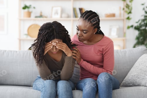 Preview: Attentive african american lady comforting her upset friend