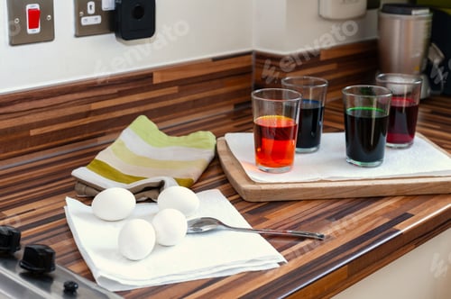 Preview: Variety of artificial neon colored brew in glasses for coloring Ester eggs.