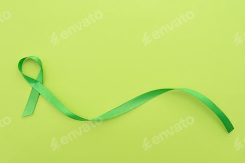 Preview: Green awareness ribbon symbolizing mental health on a green light background