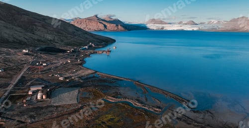 Preview: Expansive view of the abandoned settlement of Pyramiden by the turquoise waters in Svalbard
