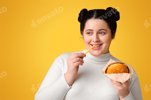 Preview: Brunette plump girl eating hamburger and french fries, enjoying fast food