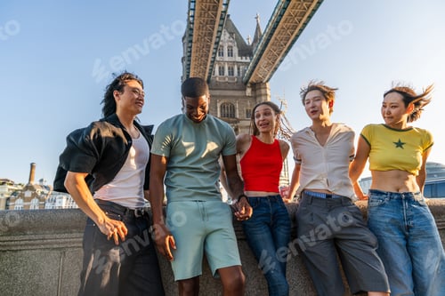 Preview: Multiracial group of happy young friends bonding in London