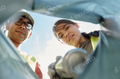 Preview: Young Hispanic Man and Woman Collecting Trash during Outdoor Cleanup Activity