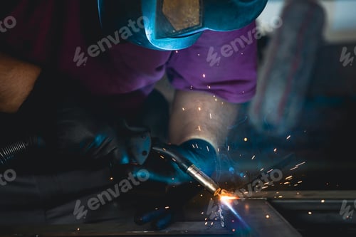 Preview: Industry worker welding iron pieces at work