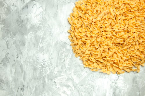 Preview: top view little raw pasta on light background photo meal many dough food color