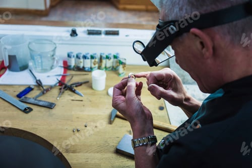 Preview: Jewellery craftsman touching platinum ring for smoothness
