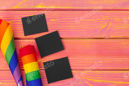 Preview: Bright rainbow gay flag on wooden background and blank space