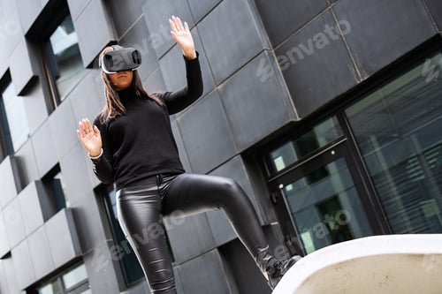 Preview: Woman Wearing Virtual Reality Glasses And Black Outfit In Futuristic City