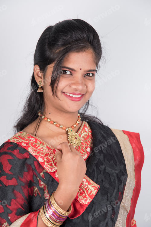Preview: Happy young beautiful Indian woman in saree.