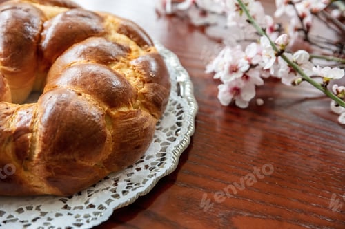 Preview: Easter sweet bread, greek tsoureki, brioche braid on wooden table, close up overhead