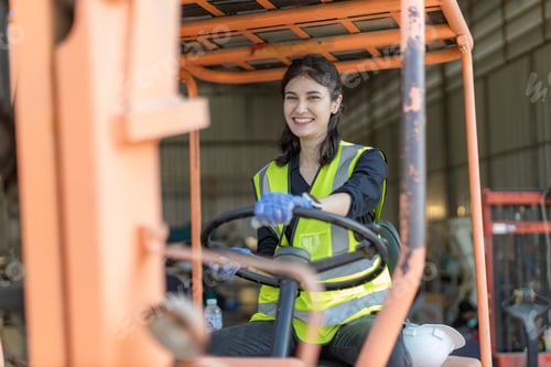 Preview: WoMan worker at forklift driver happy working in industry factory logistic ship.