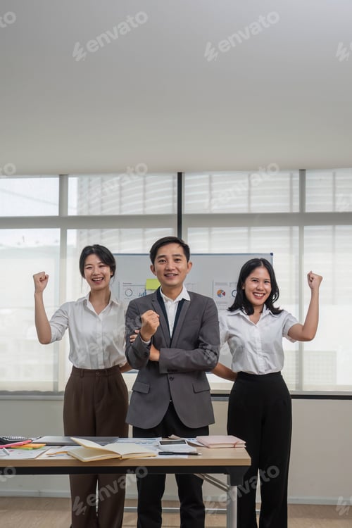 Preview: Portrait of smiling group Asian professional confident business people team standing and looking at