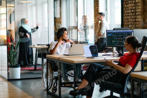 Preview: A young business group, including an African American businessman in a wheelchair, collaborates