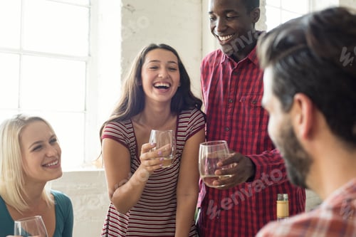 Preview: Happy friends drinking wine in a loft