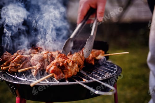 Preview: Grilling Meat Skewers Over Hot Charcoal at Outdoor BBQ