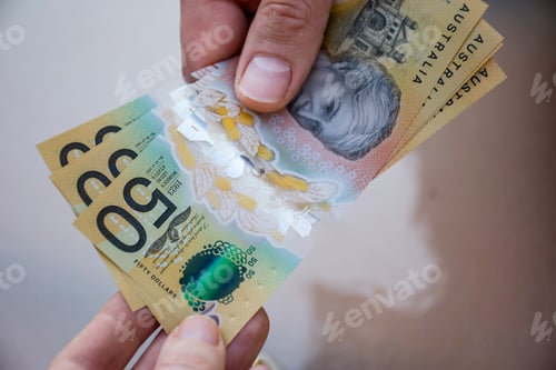 Preview: Hands holding australian dollars 50 banknotes. Finance help and payment concept.