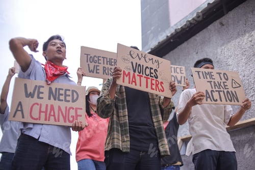 Preview: Diverse Group of Young Activists Marching and Holding Up Signs Advocating for Change
