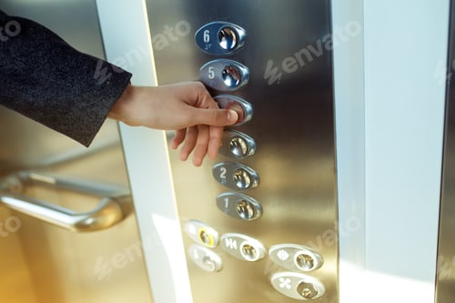 Preview: Man pressing elevator button. finger presses the elevator button. Red button. sunset light.