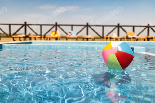 Preview: The ball floats on the water surface in the pool under the summer sun