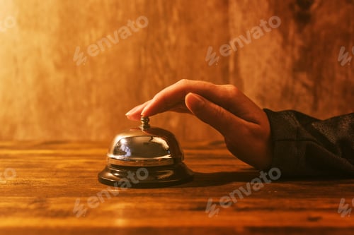 Preview: Businesswoman ringing hotel reception bell