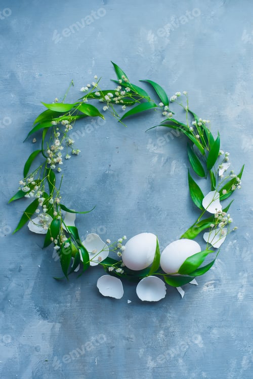 Preview: Easter wreath with eggs, green leaves and spring flowers. Floral decoration concept with copy space.