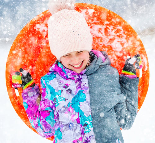 Preview: Funny girl with saucer sled outdoors