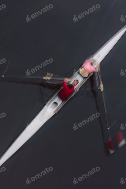 Preview: Overhead view of two people rowing in a scull, a pair in a boat