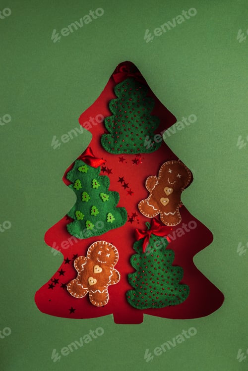 Preview: Handmade Felt Christmas Decorations in Tree Cutout on Green Background