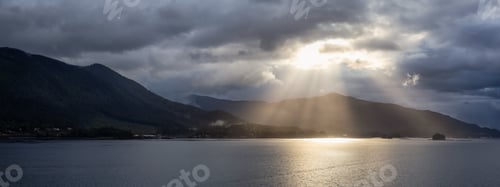 Preview: Panoramic View of Sunrays over the Ocean Coast during a stormy morning