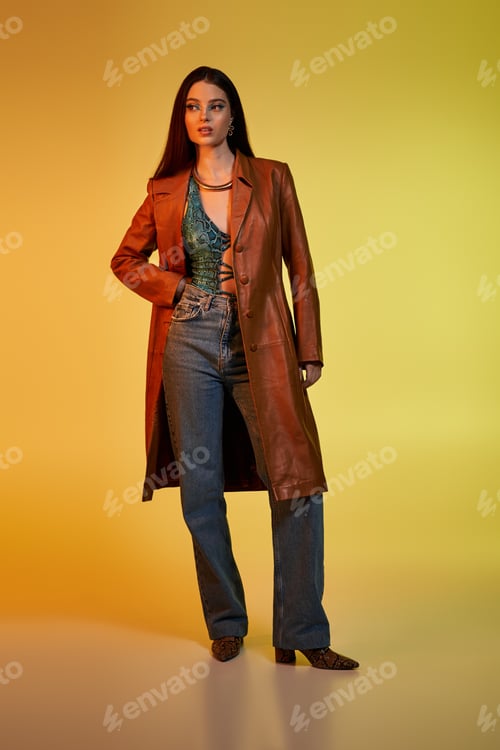 Preview: Young woman poses confidently in trendy snake print outfit, showcasing her beauty and style.