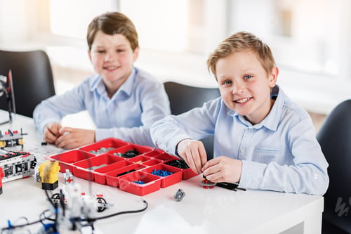Preview: Happy Smiling Children Sitting Near Table