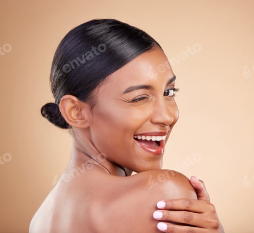 Preview: Indian woman, beauty and skincare portrait with wink, smile and looking over shoulder with wellness