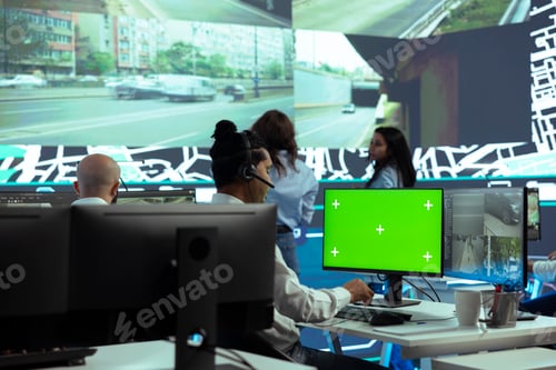 Preview: Indian employee operates on mockup display next to CCTV real time video